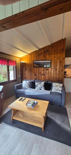 a living room with a couch and a coffee table at Chalet du Feignole in Gerbépal
