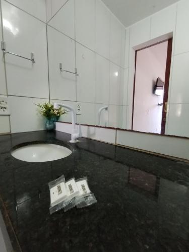 a bathroom with a sink and a mirror at Pousada Villa Zarah in São Miguel do Gostoso