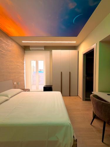 a bedroom with a bed with a painting on the ceiling at Ludogà Luxury Suite in Trebisacce