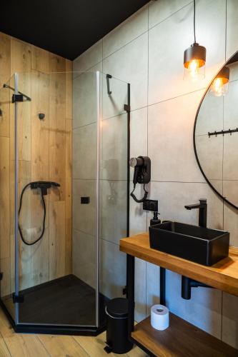 a bathroom with a sink and a shower at TATRZAŃSKIE TARASY Luxury Chalets in Małe Ciche