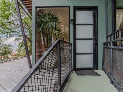 a front door of a house with a fence at The Box by Wynwood House in El Salvador