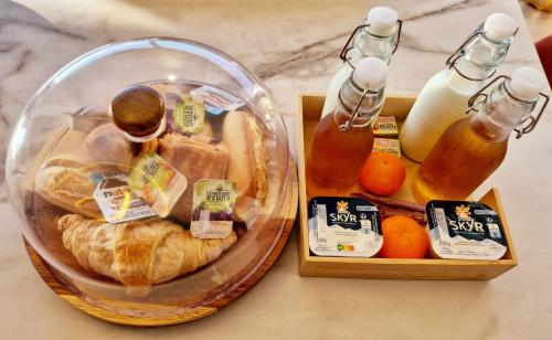 a table with a plate of bread and a glass jar of honey at Love Room - Cocon Room - Toulon - Ollioules in Ollioules
