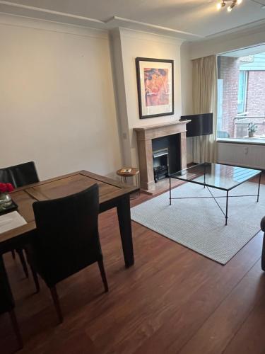 a living room with a table and a fireplace at Franciscus in Bergen op Zoom