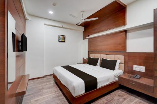 a bedroom with a bed and a television in it at Collection O Motipura Bus Terminal Formerly Hotel Navjivan in Himatnagar