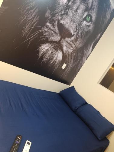 a bedroom with a picture of a lion and a bed at Espaço jr in Andradina