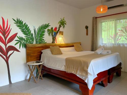 a bedroom with a bed and a plant at Hotel Villas Rio Mar in Dominical