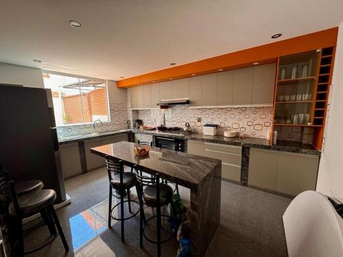a kitchen with a island in the middle of it at Modern, comfortable and convenient space in Sucre
