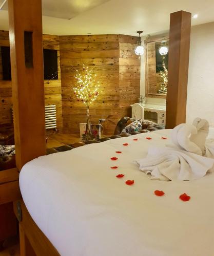 a bedroom with a bed with hearts on it at Lymestone Boutique Accommodation in Grange Over Sands