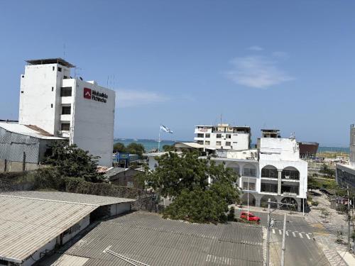 a view of a city with white buildings and a street at Hostal Shaddai in Manta