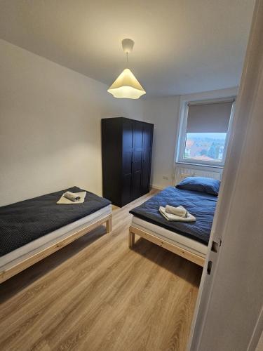 a bedroom with a bed and a large window at Moderne Wohnung gegenüber Bahnhof in Kassel