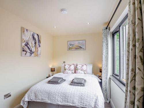 a bedroom with a bed and a window at 1 Bed in Conwy 96068 in Llangelynin