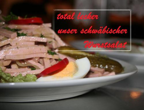 a plate of food with meat and vegetables on a table at Adam & Eva Gasthof Paradies mit Hotel in Vogt