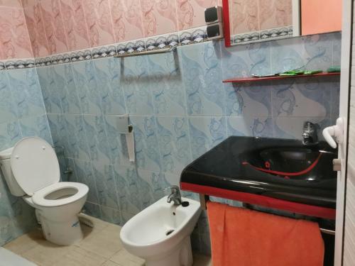 a bathroom with a toilet and a sink at Motel in Oulad Barrehil