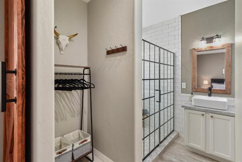 a bathroom with a sink and a mirror at Sublime Mountain Retreat Pool Table Fire-Pit Arcade Game Ideal Location w Central AC in Flagstaff