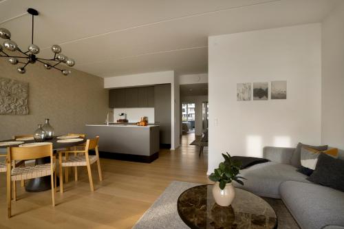 a living room and kitchen with a couch and a table at Brand New & Full Sea View Apartment in Copenhagen in Copenhagen