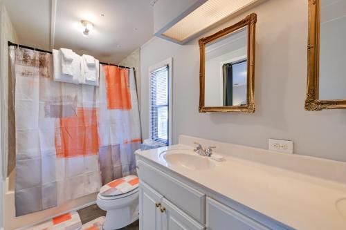 a bathroom with a sink and a toilet and a mirror at Heart of Greensboro Pet-Friendly Gem 3 Mi to Dtwn in Fisher Park
