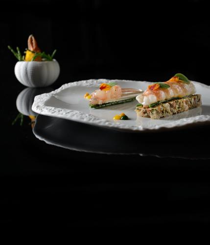 a white plate with two pieces of food on it at Le Kaïla in Méribel