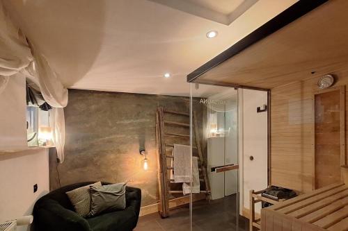 a living room with a couch and a glass wall at Ferienwohnung Häusle im Badegässla mit Sauna in Bad Staffelstein