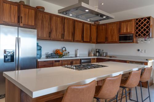 a kitchen with wooden cabinets and a white counter top at The Point At Cerritos # 4 in San Carlos