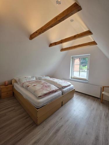 a bedroom with a bed in the corner of a room at Luxus Ferienwohnung in Kurort Jonsdorf