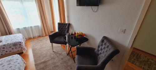 a living room with two chairs and a table at VISOKO Room in Visoko