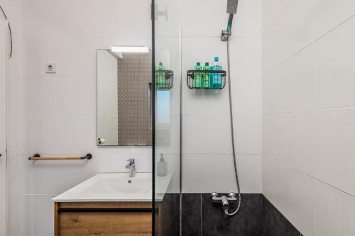 a bathroom with a sink and a shower at Private Room in Family Home with Pool in Sesimbra