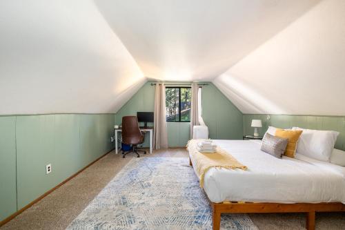 a bedroom with a large bed and a desk at Whispering Pines: Foosball Grill More in Mountainaire