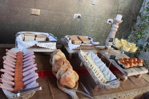 a buffet with various types of bread and pastries at Hotel Tikary in Arequipa