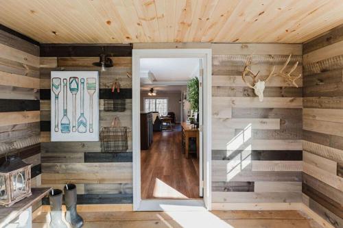 a room with wooden walls with a door and a hallway at Happy Hollow Resort in Blue Eye