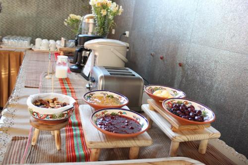a counter with bowls of food on a table at Hotel Tikary in Arequipa