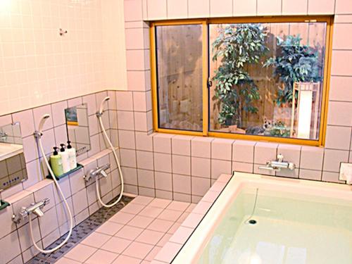 a bathroom with a tub and a window at Minamiuonuma - Hotel - Vacation STAY 23091v in Myōgasawa