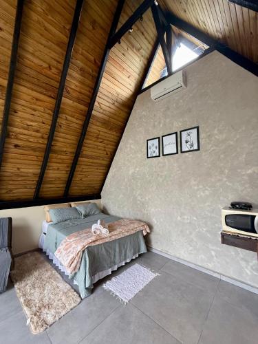 a bedroom with a bed in a attic at Cantinho do Vale# in Pomerode