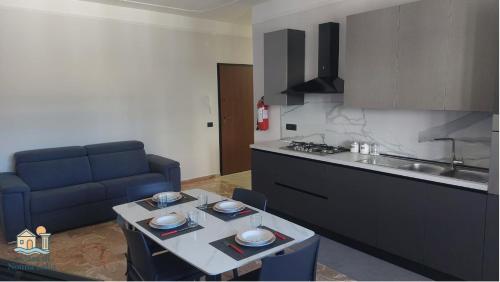 a kitchen with a blue couch and a table in a room at A Casa di Nonna Lidia in Crotone