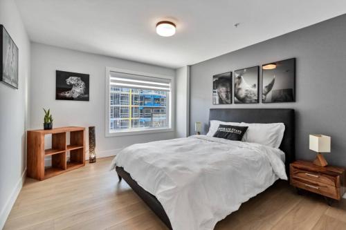 a bedroom with a large bed and a window at Corporate Stays Millennium Boulevard 1 Bedroom in Moncton