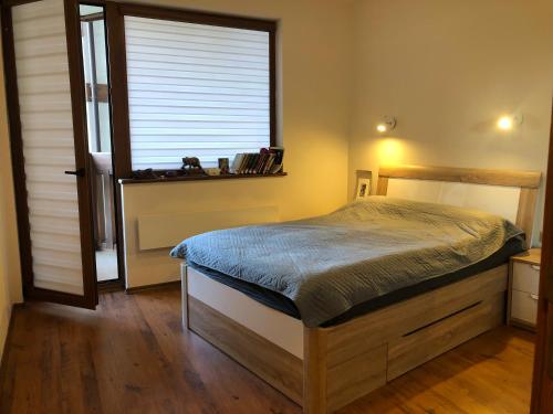 a bedroom with a bed and a large window at Artistic Neon Apartment in Bansko