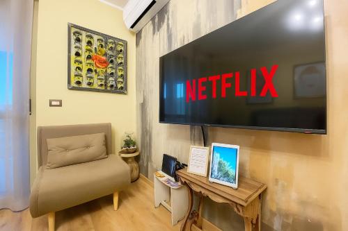 a living room with a television on a wall at [3' a piedi dal mare] CASITA DEL MAR...Mare & Arte in Grottammare