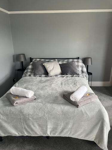 a bed with two towels and two pillows on it at Apartment 288 in Lower Swanwick