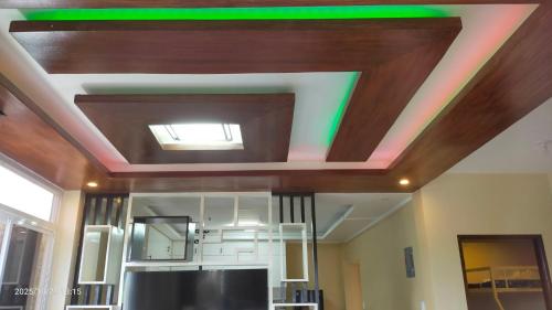 a ceiling with a green light in a room at J Jireh Residences in San Jose del Monte
