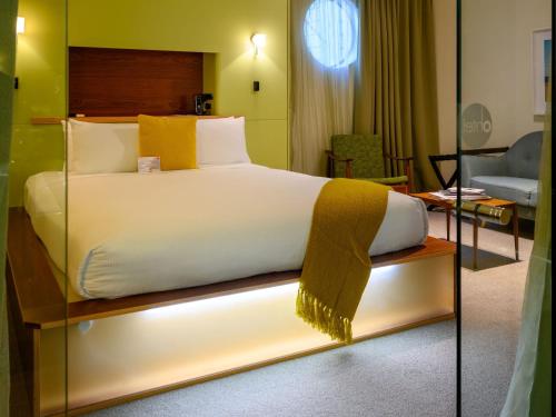 a bedroom with a bed with a light on it at Ohtel Wellington in Wellington