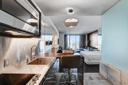 a kitchen with a sink and a bed in a room at Palms Place- Strip View- High floor- Free parking in Las Vegas