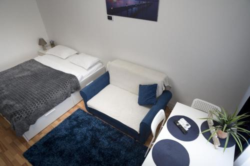 a small bedroom with a bed and a chair at Casa Rusu - Govandari -Self check in-24h Netflix in Reşiţa