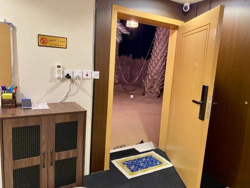 a room with a door leading into a room with a room at The Rock Hostel in AlUla