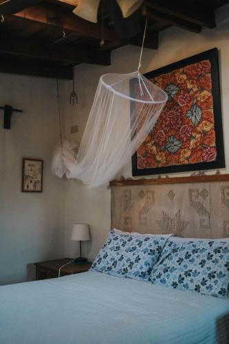 a bedroom with a bed with a mosquito net above it at La Mata de Nuez in Valle de Guadalupe