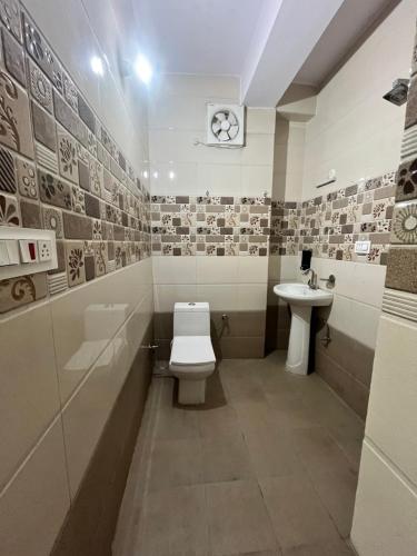 a bathroom with a toilet and a sink at Wonder View in Shimla