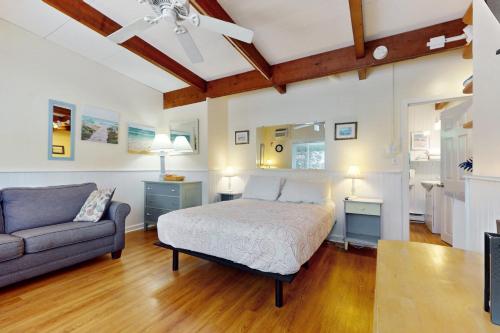 a bedroom with a bed and a couch at Sparkling Sands Holiday House M2 in Moody