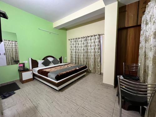 a bedroom with a bed and a green wall at Wonder View in Shimla