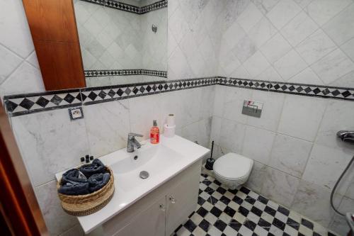 a bathroom with a sink and a toilet at Appart Julia Gammarth Sup in La Marsa