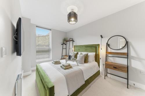 a bedroom with a large bed and a television at Lambert House Two in Harrogate