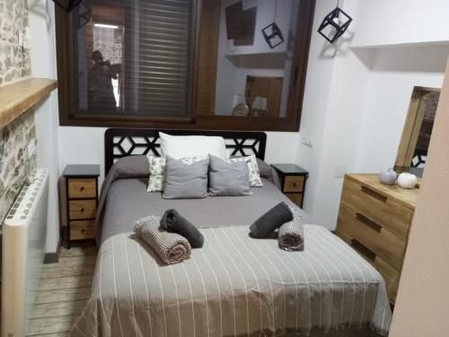 a bedroom with a bed with two pillows on it at Las Golondrinas in Galaroza