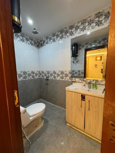 a bathroom with a toilet and a sink at Gulberg Heights Gulberg Greens in Islamabad